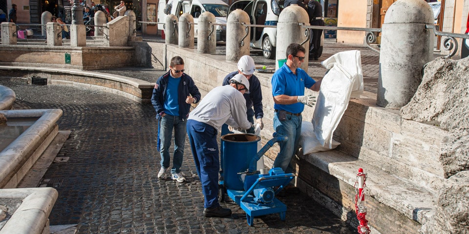 Collecting Coins from the Trevi Fountain Rome