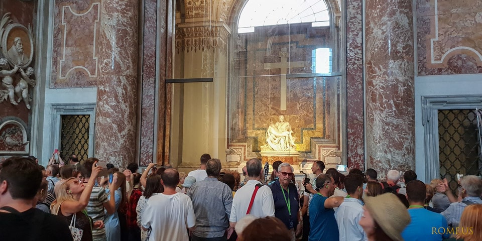 Crowd of tourists at the statue of Michelangelo's Pieta in St Peter's-Basilica