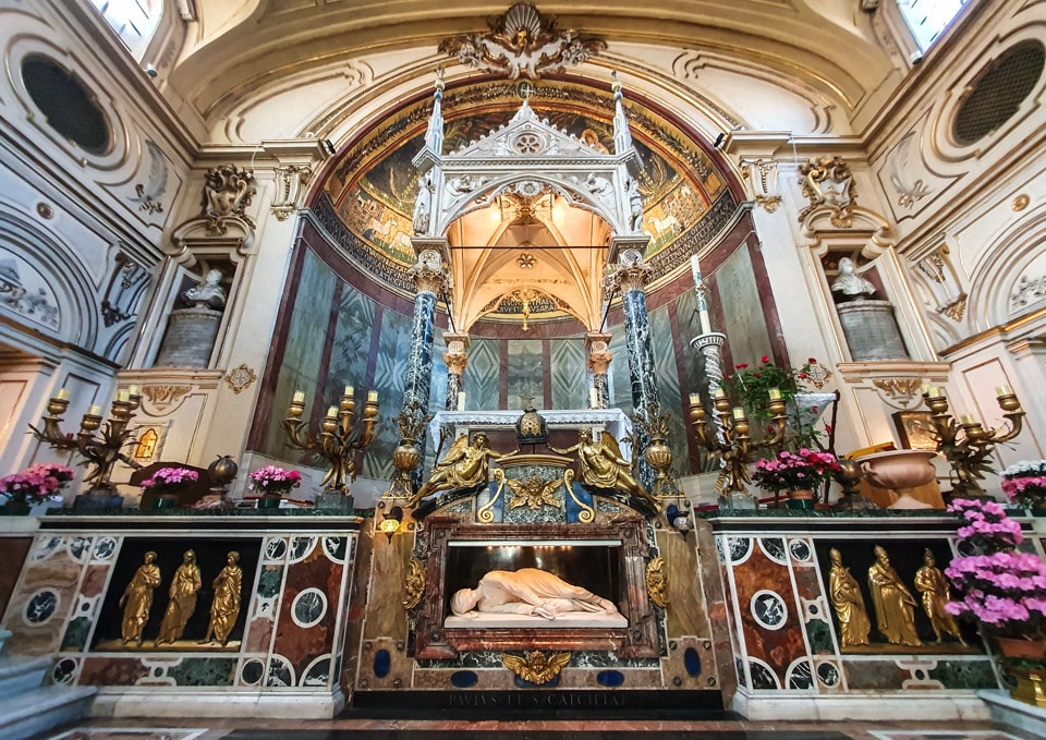 Sculpture of Saint Cecilia in front of the altar