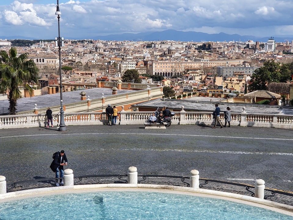 Panorama of Rome from the Acqua Paola fountain terrace on the Janiculum hill, with the dome of the Pantheon and the twin towers of Trinita dei Monti visible on the skyline