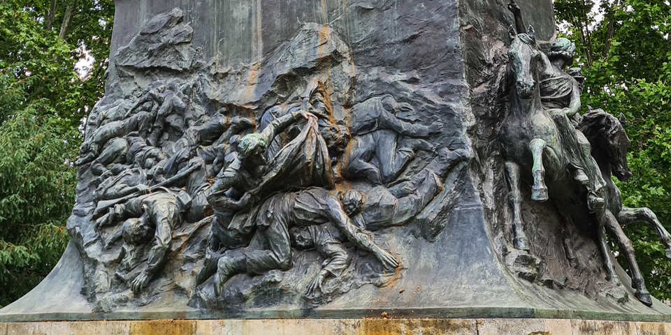 Bronze relief showing Anita Garibaldi searching among fallen fighters after the Battle of Curitibanos