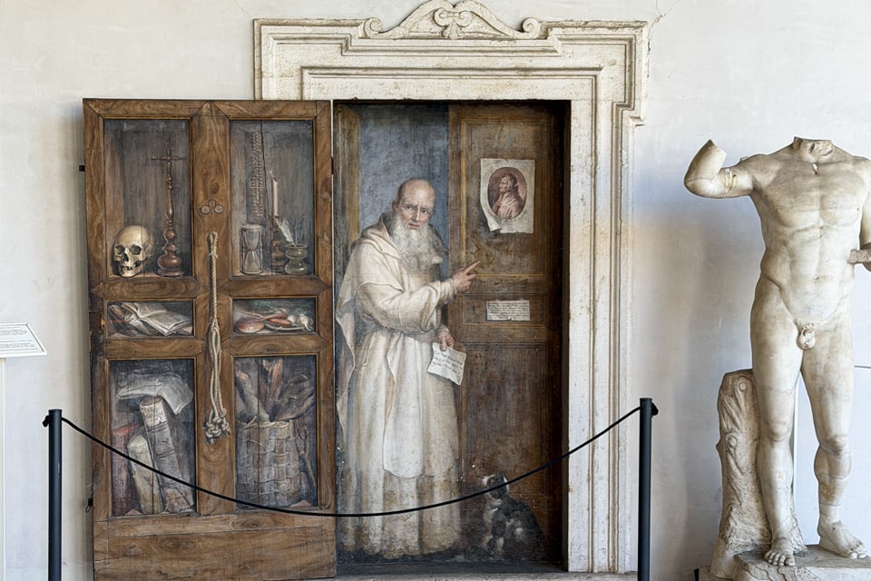 Trompe-l'oeil fresco of a Carthusian monk at a false door by Filippo Balbi, cloister of the Baths of Diocletian, Rome