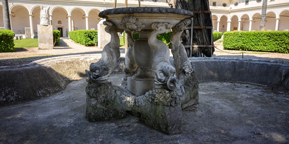 The 1695 dolphin fountain at the center of the Great Cloister of the Baths of Diocletian, Rome