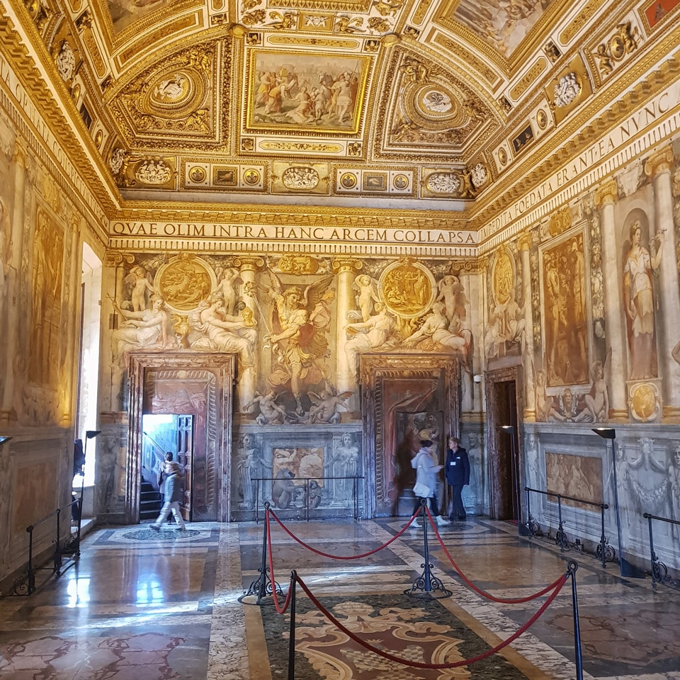Frescoed Sala Paolina with a gilded coffered ceiling and Latin frieze inside Castel Sant'Angelo, Rome
