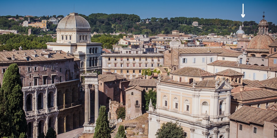 Faro del Gianicolo marked with an arrow on the western skyline as seen from Capitoline Hill in Rome