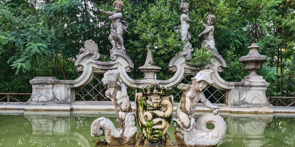 Putti, dolphins and the crowned Visconti biscione on the Fountain of the Putti at Villa Sciarra