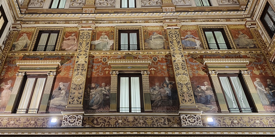 Cellini frescoes of female virtues labeled in Latin above the windows of Galleria Sciarra, Rome