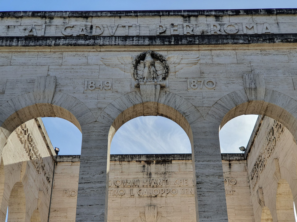 Ai Caduti per Roma inscription with the dates 1849 and 1870 above the arches of the Garibaldi Ossuary