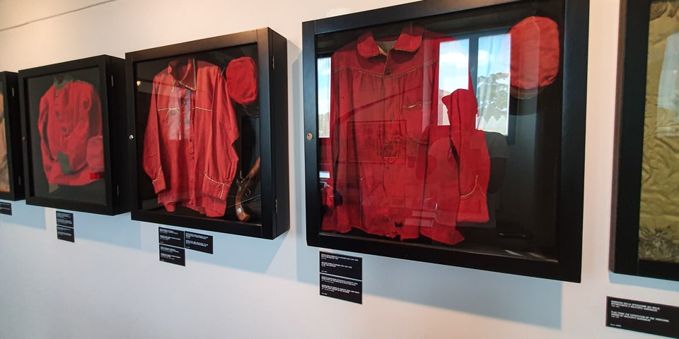 Red shirts and caps associated with Garibaldian volunteers displayed at Porta San Pancrazio