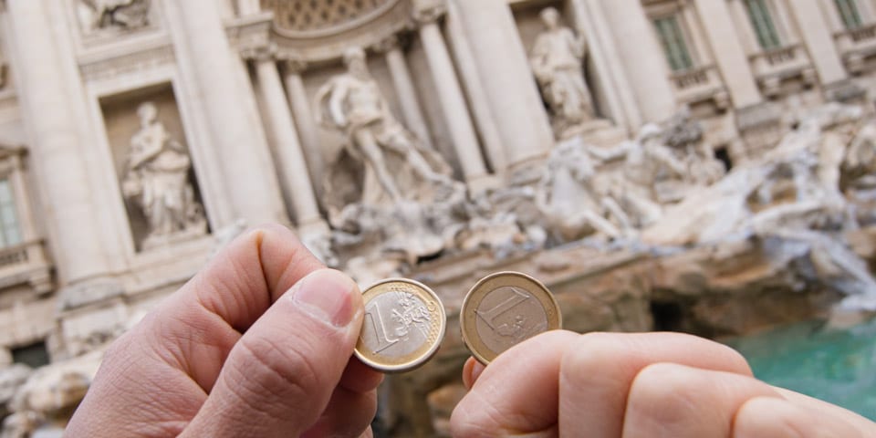 tossing coins into the Trevi Fountain