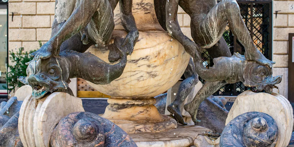 turtle fountain in Rome close up details of sculptures of a young man and a dolphin